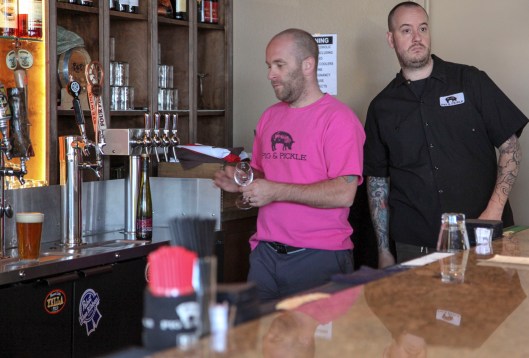 pig and pickle copartner and worker behind bar