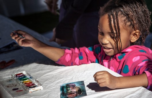 little girl proud of art